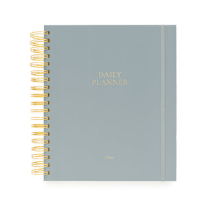 Light blue daily planner with gold spiral binding and daily planner and 2026 foil stamped in gold on cover
