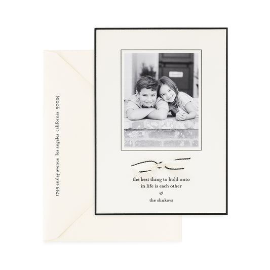 cream and black custom holiday card with ribbon detail and photo