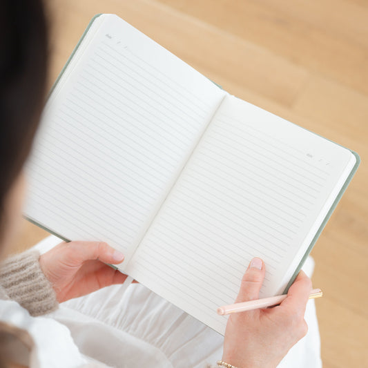 Blank lined pages of journal in hand