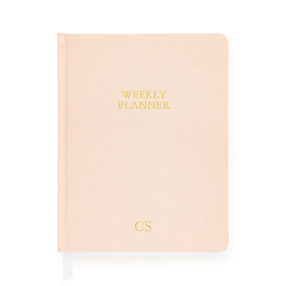 Pale pink weekly planner with gold foil initials