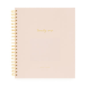 Blush planner with gold spiral binding and 'twenty-six' on cover