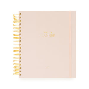 Blush pink daily planner with gold spiral binding and daily planner and 2026 in gold foil on the cover