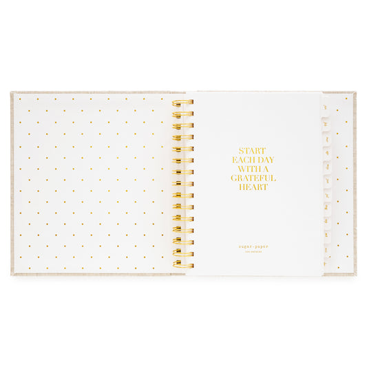 Interior of open concealed agenda with title quote of "start each day with a grateful heart" in gold foil