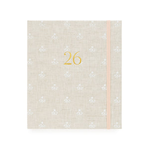 Beige and white floral pattern fabric planner with the gold foil 26 on the cover