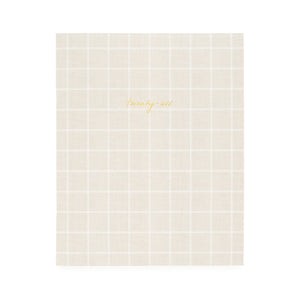 Flax and white check planner with twenty-six in gold foil on the cover