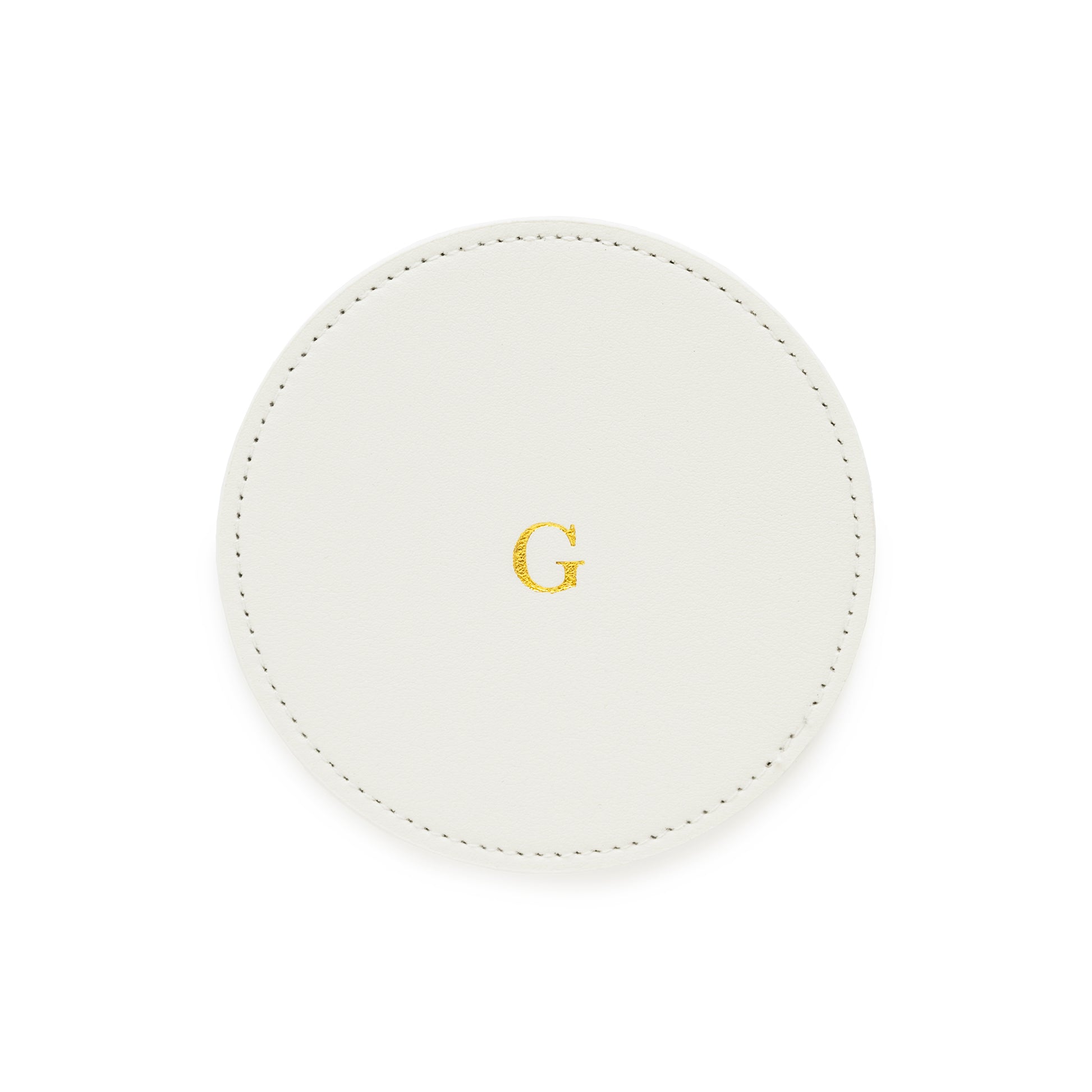 white monogrammed coaster with gold foil g on it