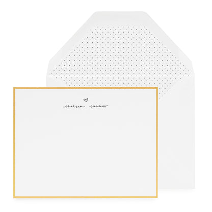 gold bordered custom stationery card with black letterpress ink with script name and heart and black pindot liner in white envelope