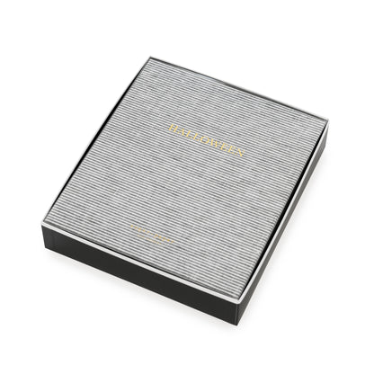 Black and white striped fabric bound book with 'halloween' in gold foil stamped on the cover in a black box with a white piping and a clear cover