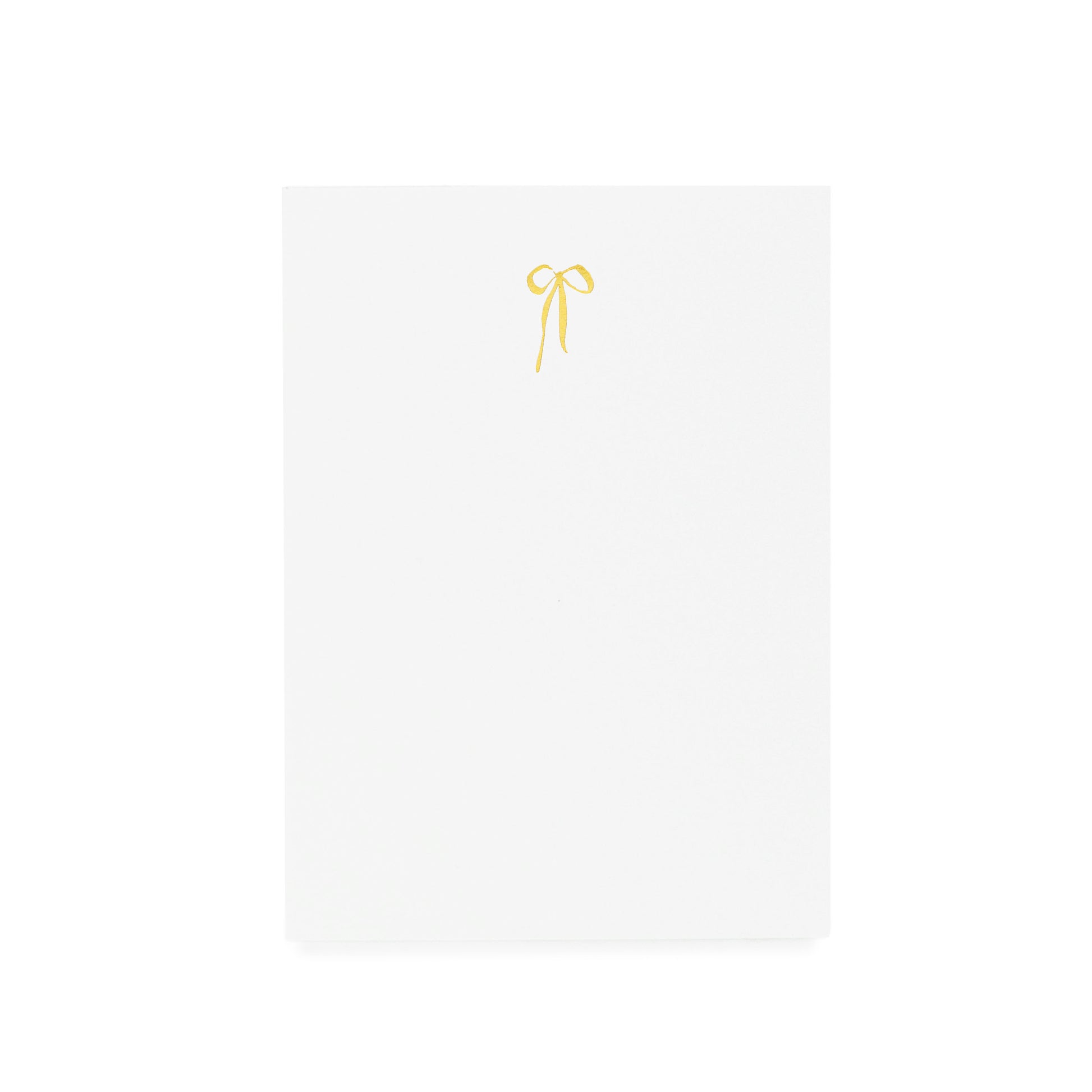 White notepad with gold hand drawn bow foil printed on it