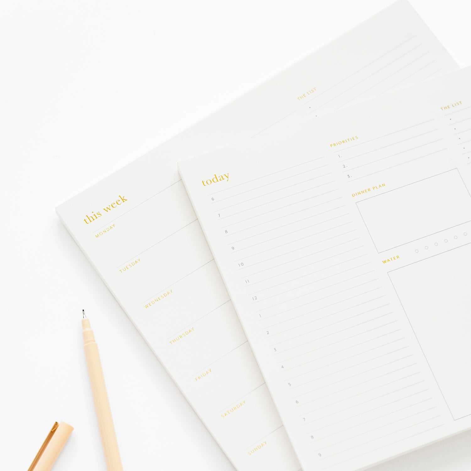 stacked today and weekly white and gold foil notepads