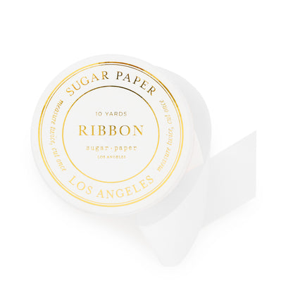 white ribbon spool with gold foil details