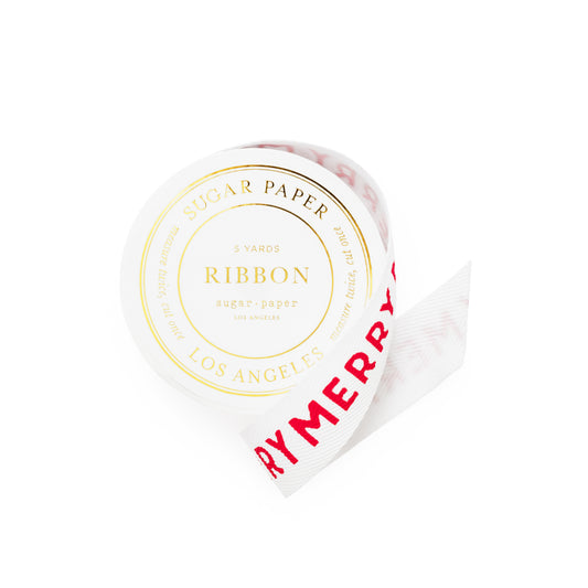 A roll of white sugar paper ribbon with red 'MERRY' text printed on it, shown on a clean white background. The round label on the roll reads 'SUGAR PAPER RIBBON LOS ANGELES' in gold foil