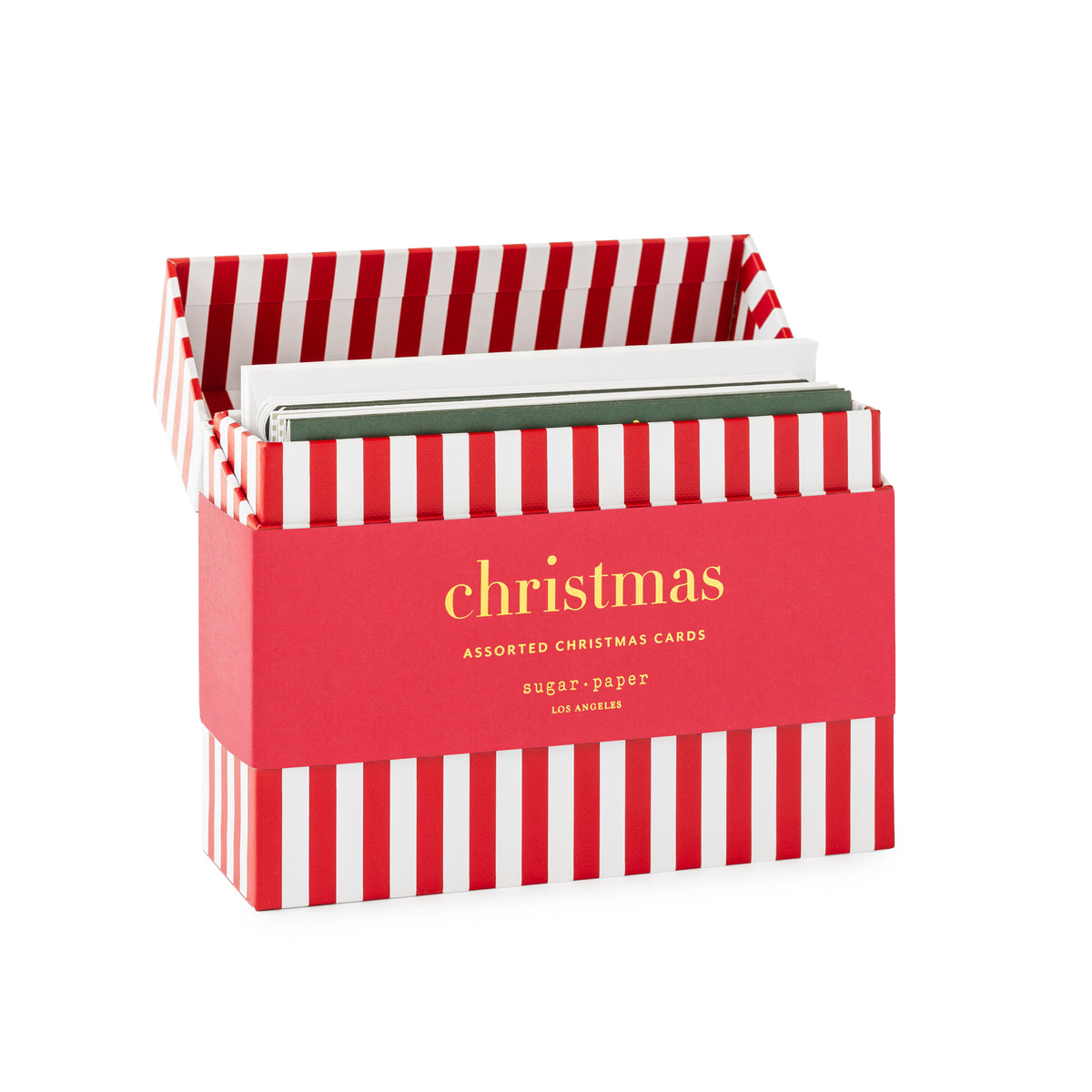 A box of assorted Christmas cards, featuring a red and white striped box with gold lettering on the front band reading 'christmas assorted christmas cards.' Inside the box features green and white cards and envelopes
