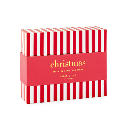 A boxed set of Christmas cards featuring a red and white striped box with a red paper band around the middle that reads 'christmas ASSORTED CHRISTMAS CARDS' in gold lettering