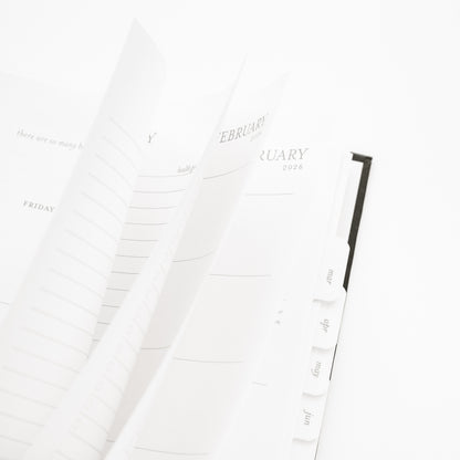 Calendar pages for February 2026 flipping open of the spiral planner