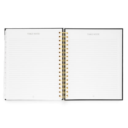 Open spiral planner with lined note pages with "Take Note"