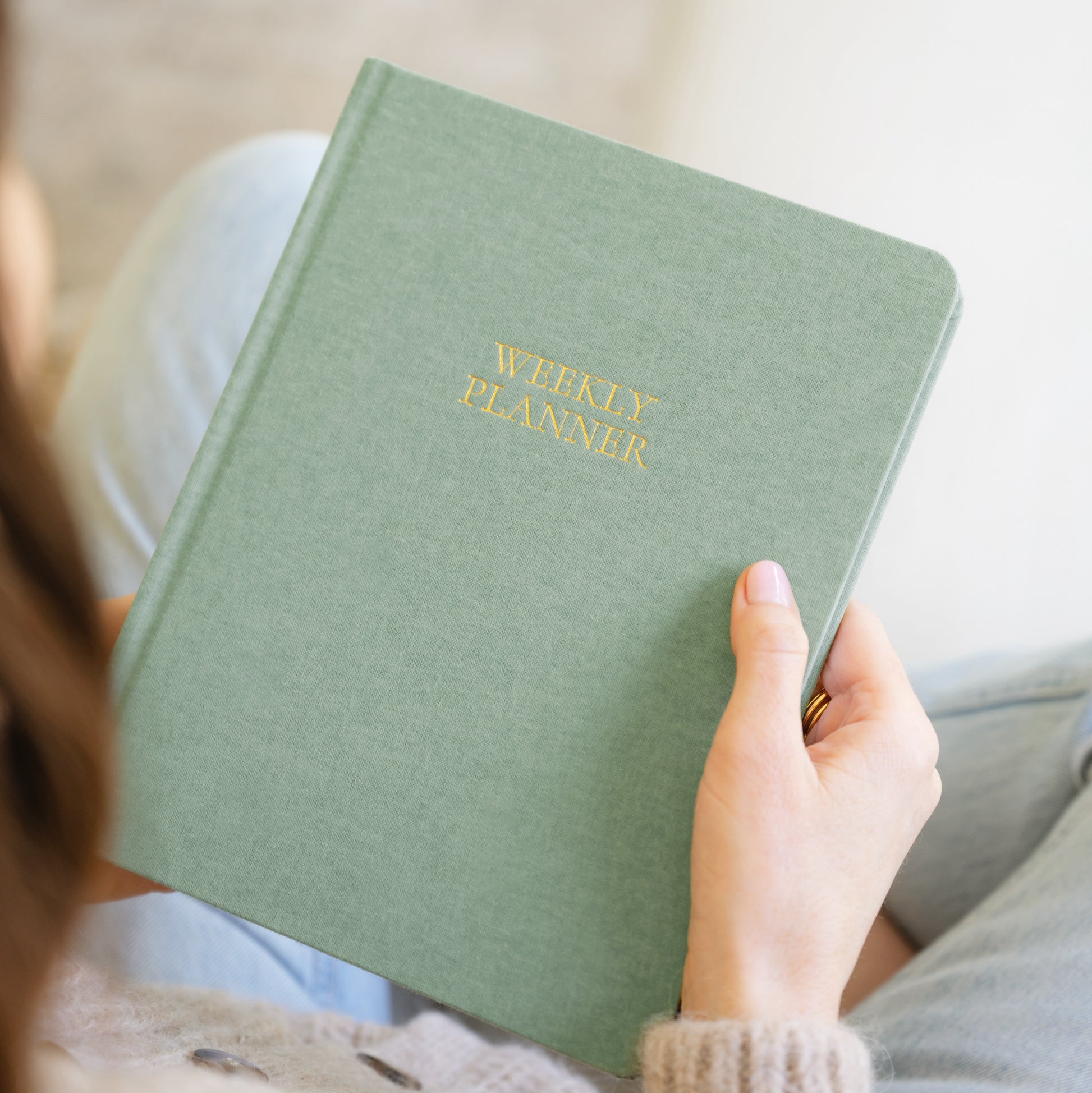 Sage weekly undated planner in hands