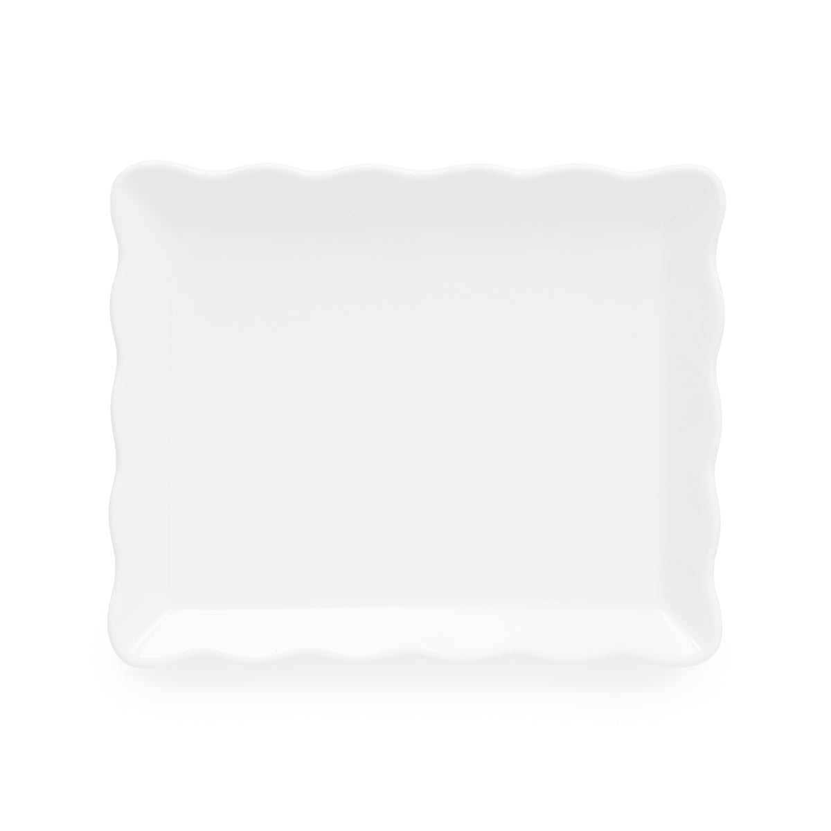 A white rectangular decorative tray with scalloped wavy edges