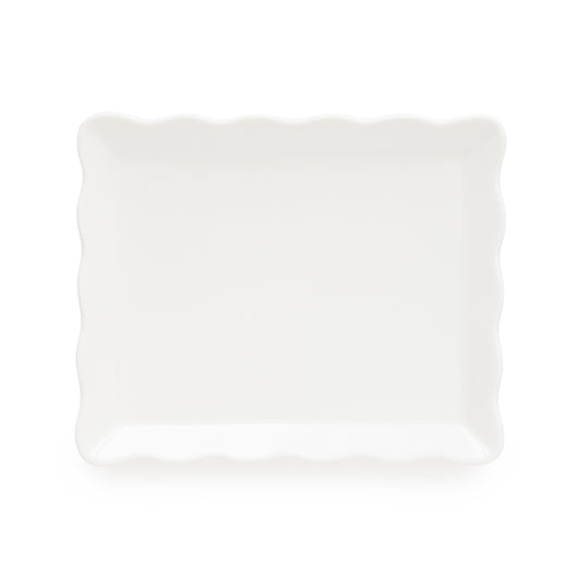 A white rectangular decorative tray with scalloped wavy edges