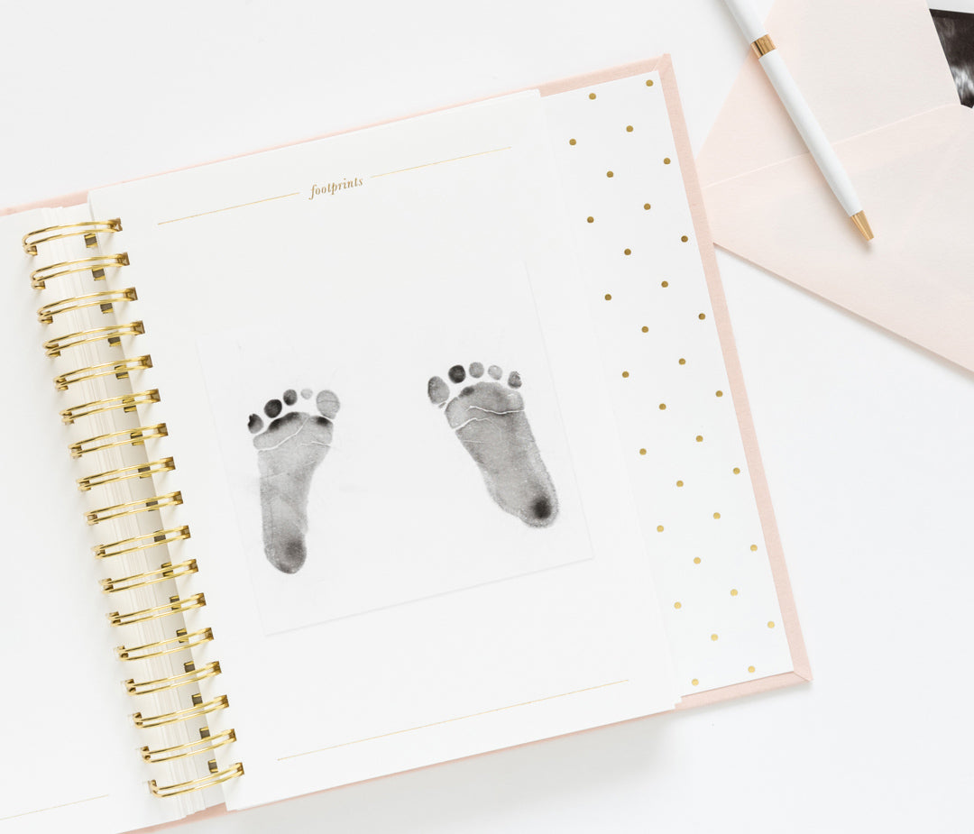 Interior page of baby book showing baby's footsteps