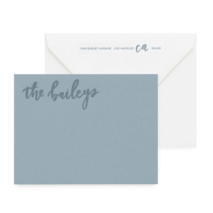 slate blue card with tonal text, white envelope